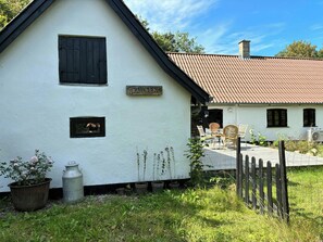 A white building with a black roof, a sign reading 'Trailsend,' and a wooden fence. - Country house with wild garden and field views (Vig)