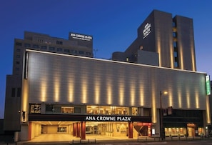 A modern building with a prominent sign reading 'ANA CROWNE PLAZA.'