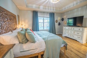 A bedroom with a bed, a dresser, a television, and a window with curtains. - 3 Bedroom/2 Bathroom Lake Park Long Pond Oasis (Lake Park)