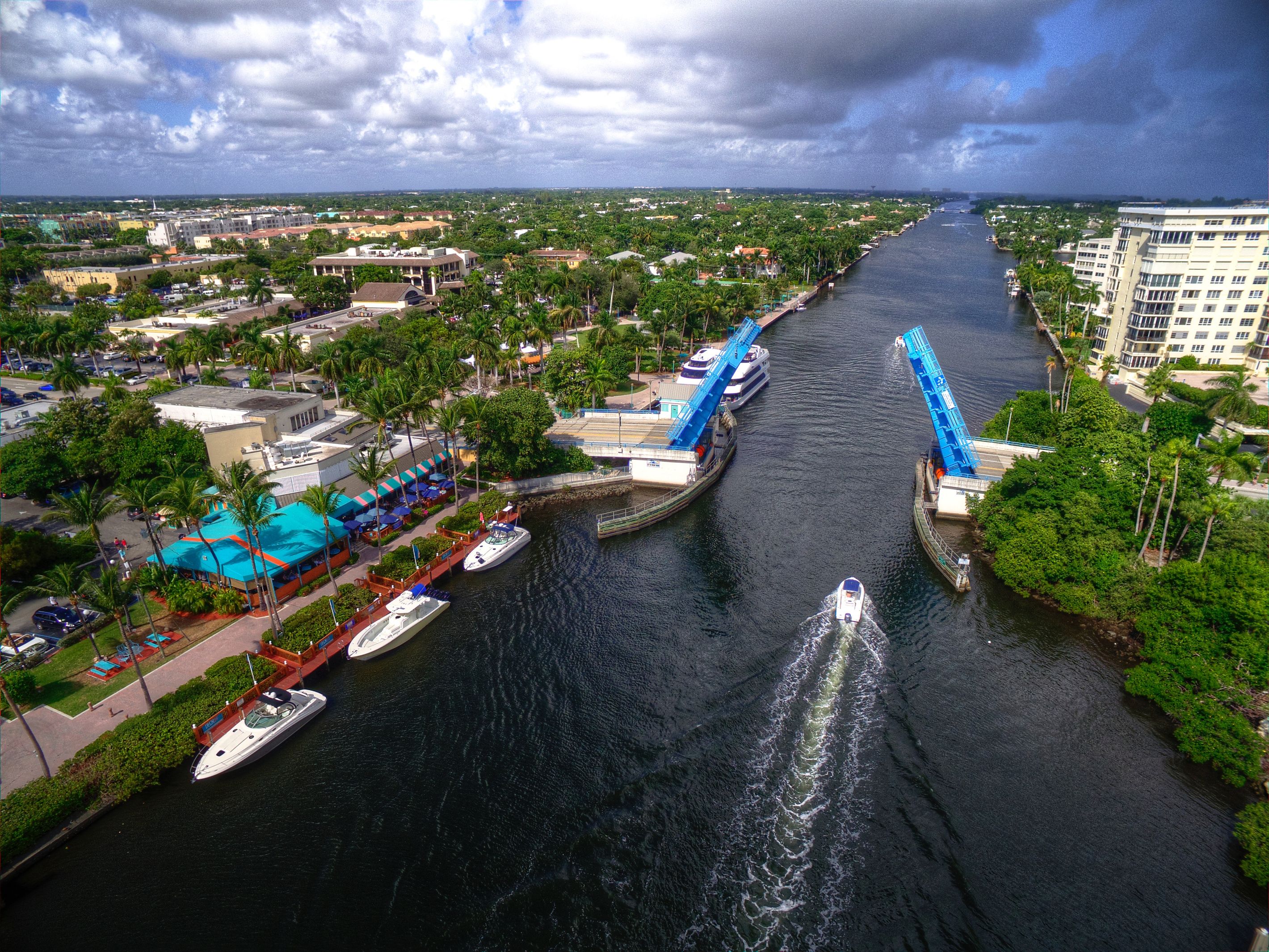 A river with boats, a bridge, and buildings along the banks.