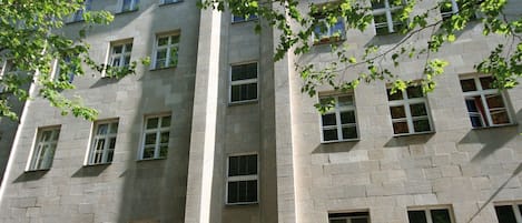 A multi-story building with a symmetrical facade, large windows, and a central entrance.
