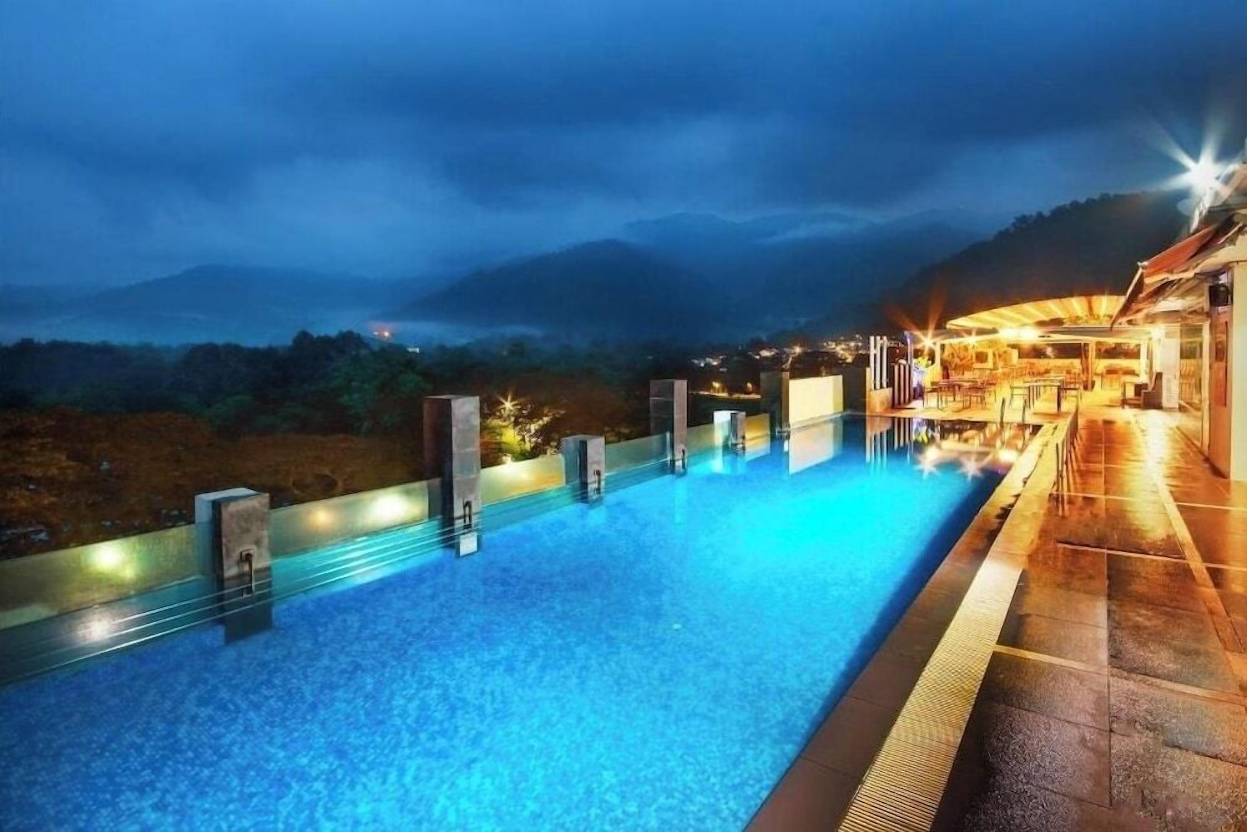 A swimming pool with a view of mountains in the background.