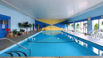 An indoor swimming pool with clear water, marked depth lines, and a 'No Diving' sign.