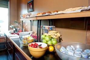 A buffet setup with various food items and condiments. - Podollan Rez-idence Fort Mcmurray (Fort McMurray)