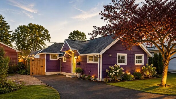A two-story house with a purple exterior, a front porch, and a well-maintained lawn. - Cozy Summerville Cottage, Sleeps 6, Pet Friendly, Fully Fenced Back Yard (Rochester)