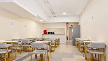 A conference room with tables and chairs arranged for a meeting.