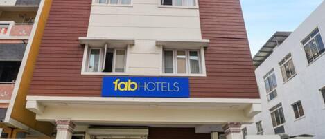 A multi-story building with a sign for 'fabHOTELS' indicating a hotel establishment.