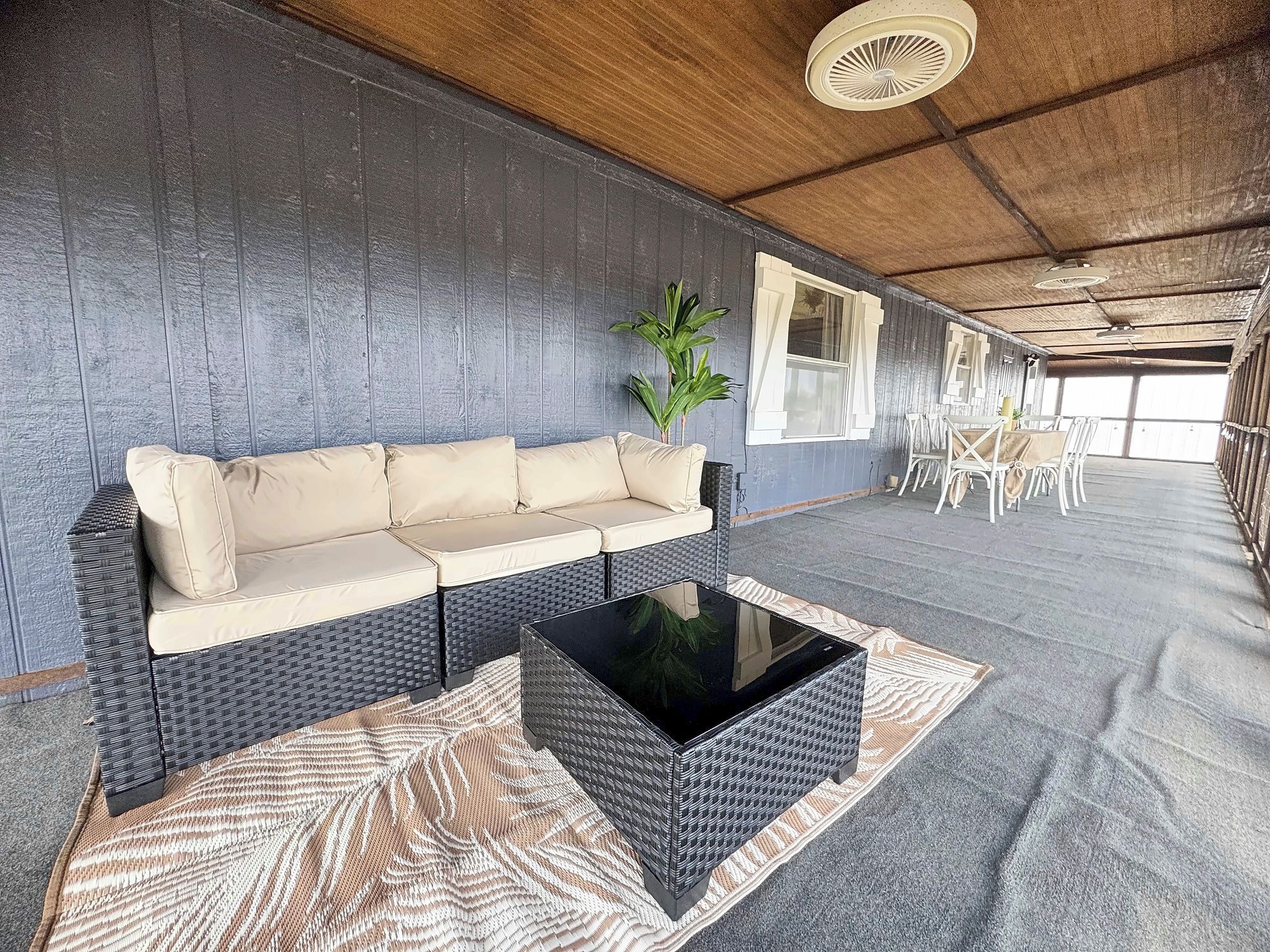 A room with a sofa, a coffee table, and a patterned rug.