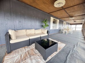 A room with a sofa, a coffee table, and a patterned rug.