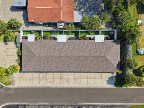 An aerial view of a building with a flat roof, surrounded by greenery and a parking lot. - Saltwater & Bubbles 1 | Indian Rocks Beach (Indian Rocks Beach)