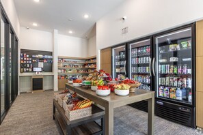 A self-service kiosk area with refrigerated beverage dispensers and a variety of snacks and beverages. - Modern 2BR near PGA and Universal Studios (Frisco)