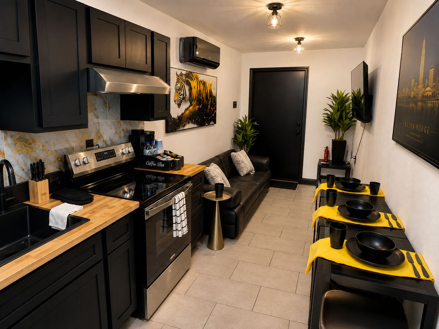 A modern kitchen with black cabinetry, a stainless steel stove, and a coffee bar.
