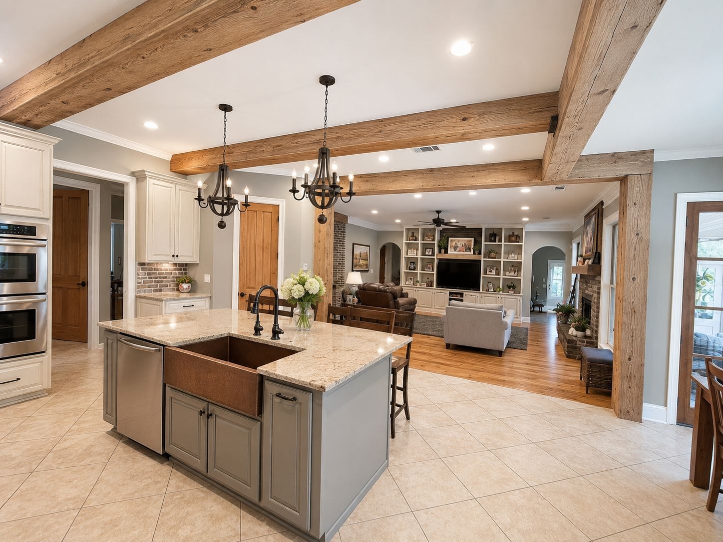 A spacious kitchen with a large island, built-in appliances, and a dining area with a fireplace.
