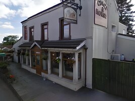 A building with a sign reading 'The Lion & Rose' and a smaller sign above the entrance.