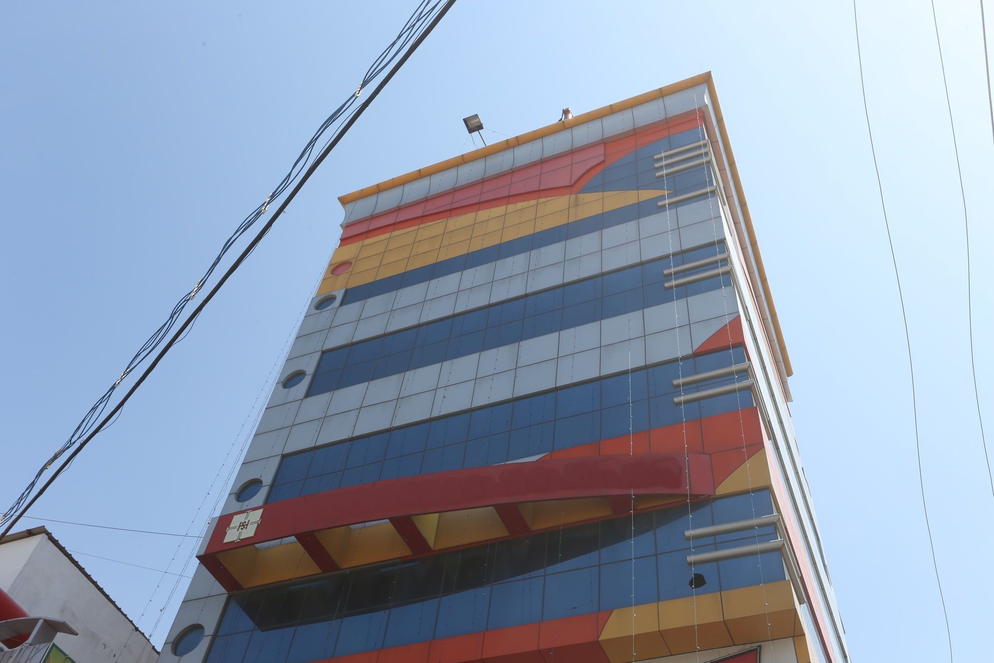 A multi-story building with a distinctive facade featuring geometric patterns and a series of balconies.