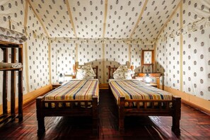 A room with two wooden beds, a wooden wardrobe, and a mirror on the wall. - Wind Desert Camp (Jaisalmer)
