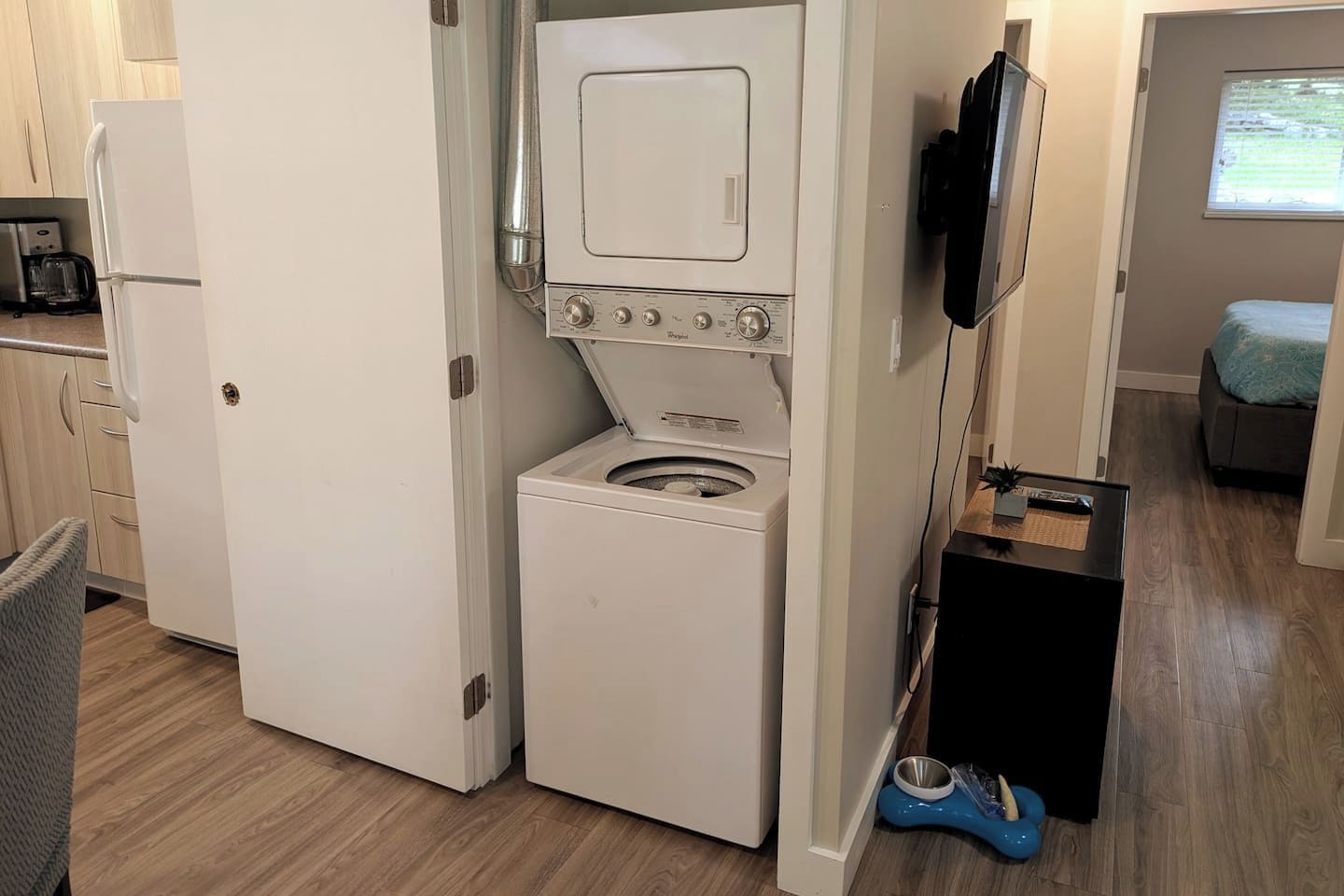 A compact kitchen with a built-in washer and dryer, a microwave, and a small dining area.