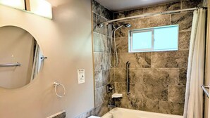 A bathroom with a bathtub, a shower, a sink, and a vanity. - Blacktail Cabin: Hot Tub, Playground, BBQ, Trails (Halfmoon Bay)