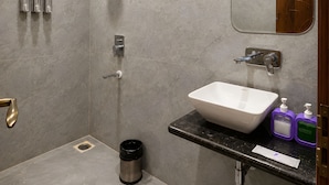 A modern bathroom with a shower, a sink, and a mirror. - ZenithSuites - Vrindavan (Vrindavan)