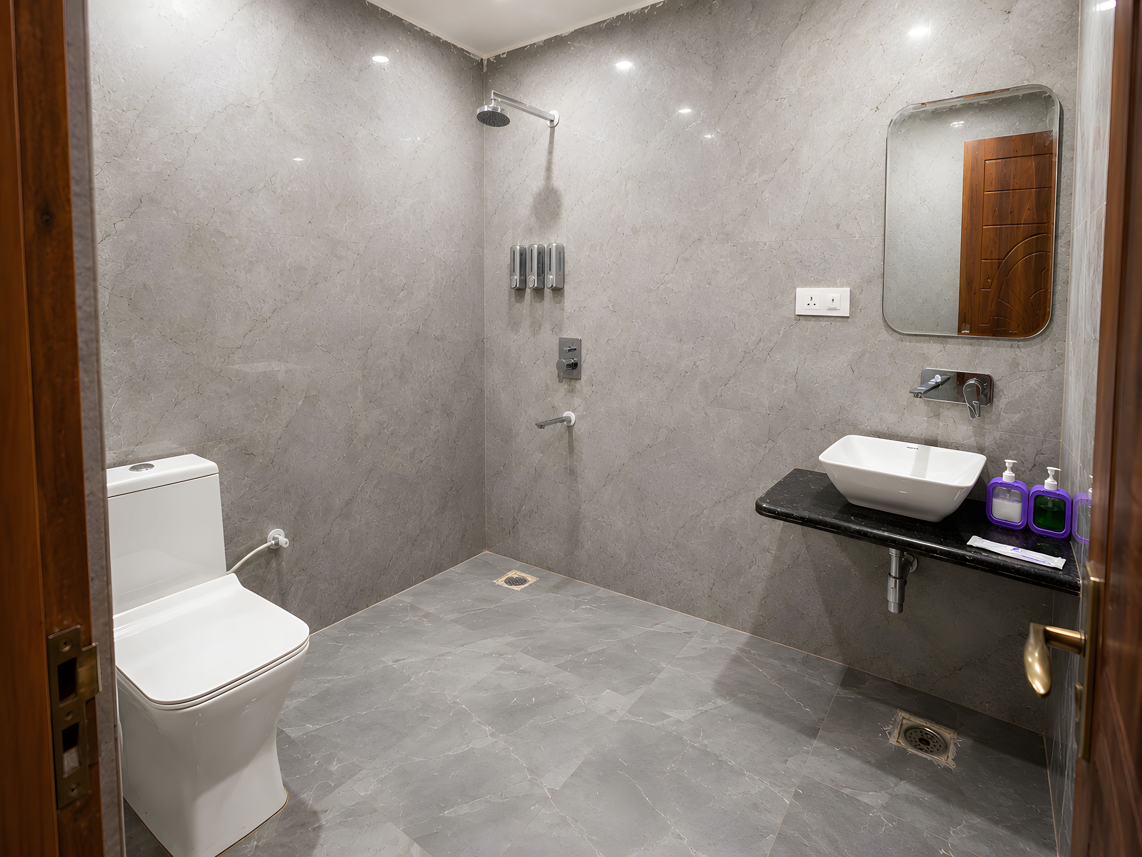A modern bathroom with a toilet, shower, and sink.