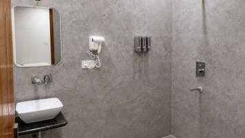 A modern bathroom with a sink, mirror, and toilet.