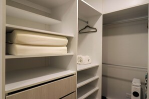 A walk-in closet with shelves, a hanging rack, and a built-in heater. - w* | Modern 2BR w/ Balcony in Prime Miraflores (Miraflores)