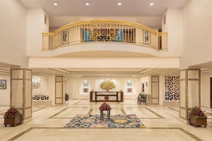A spacious lobby with a marble floor, a central seating area, and a decorative railing. - Kufri Holiday Resort (Theog)