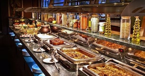 A buffet with various food items and condiments. - Fort Khejarla (Bilara)