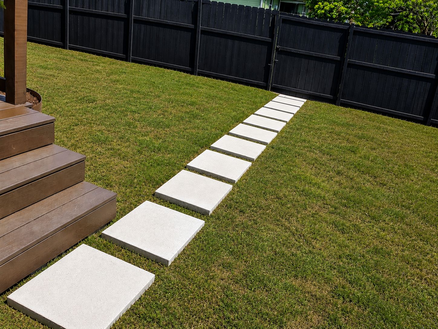 A pathway with steps leading to a wooden deck.