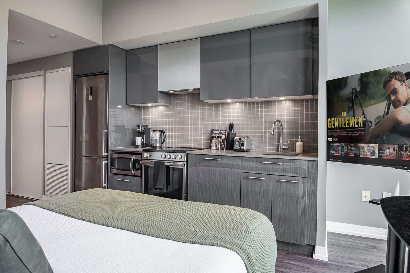 A modern kitchen with stainless steel appliances, a built-in oven, and a microwave.