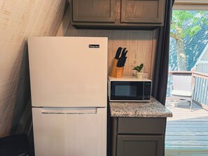 A kitchen with a white refrigerator, a microwave, and a wooden countertop. - Table Rock Lake A-Frame Cabin | Black Oak Lodge 2 (Lampe)