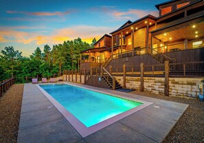 A wooden cabin with a swimming pool, stairs, and a deck. - Lux•Insane Views•Sleep 26•Heated Pool•Game Room (Broken Bow)