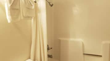 A bathroom with a bathtub, a shower curtain, and a towel rack.