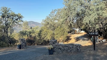A driveway leading to a house with a stone wall and a sign displaying the number 40872.