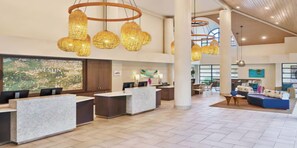 A hotel reception area with a modern design, featuring a reception desk, seating area, and decorative lighting. - Beachside or Poolside-Westin St. John–Sunset Bay Villas - Thanksgiving Week (Cruz Bay)