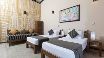 A hotel room with two beds, a sofa, a wall-mounted painting, and a wooden cabinet.