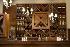 Una bodega con estanterías de madera y una vitrina central en forma de cruz.