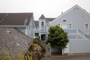 A residential area with houses featuring gabled roofs and a central building with a tower-like structure.