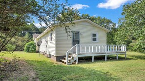 A small, single-story house with a front porch and a satellite dish. - Newly Renovated, "Daisy" 3 Bedroom, 2 Bath Home! (Hanceville)