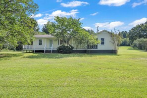 A single-story house with a front porch, a small front yard, and a clear blue sky. - Newly Renovated, "Daisy" 3 Bedroom, 2 Bath Home! (Hanceville)