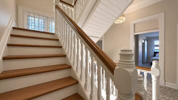 A staircase with white balusters and wooden steps leading to a landing.