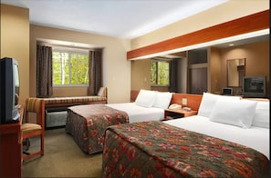 A hotel room with two beds, a desk, a chair, a television, and a window with curtains. - Microtel Inn By Wyndham Parry Sound (Parry Sound)