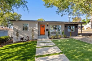 A modern two-story house with a bright orange front door, a covered porch, and a well-maintained lawn. - Gated Yard, King Bed, Parking, Ranch-Style La Mesa (La Mesa)