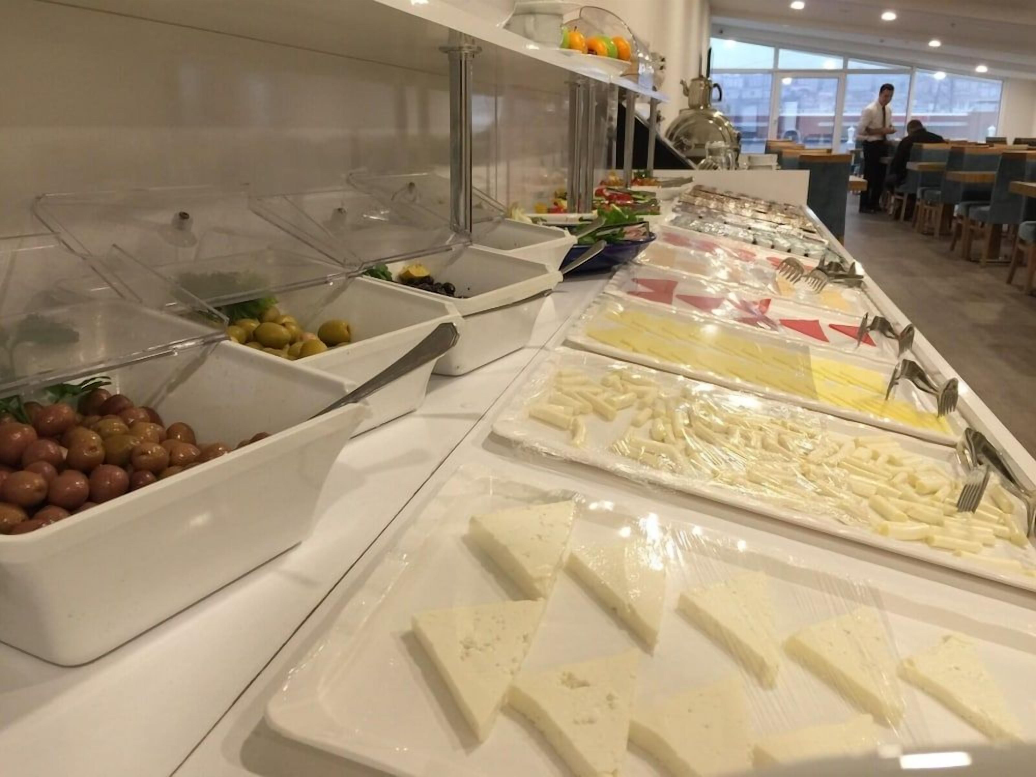 A buffet with various food items and utensils.