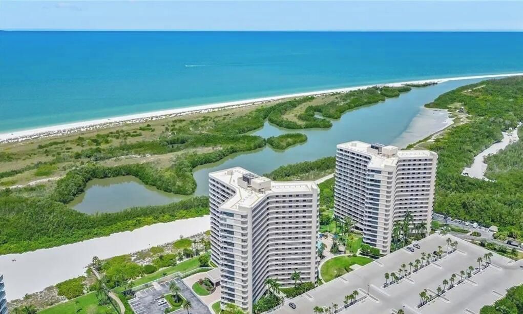 A high-rise hotel with a view of the ocean and mangrove-lined waterways.