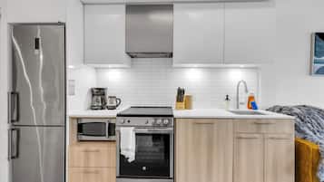 A modern kitchen with stainless steel appliances, a built-in oven, and a microwave.