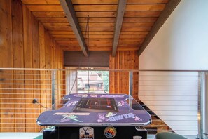 A wooden interior with a foosball table featuring cartoon characters. - Sierra Sky Retreat, Sleeps 6, Mountain Views, Pool/Hot Tubs, Near Canyon Lodge (Mammoth Lakes)