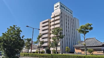A multi-story building with a prominent sign at the top.