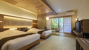 A hotel room with two beds, a TV, a desk, and a view of trees through a sliding door. - Hakone Kowakudani Onsen Mizunoto (Hakone)