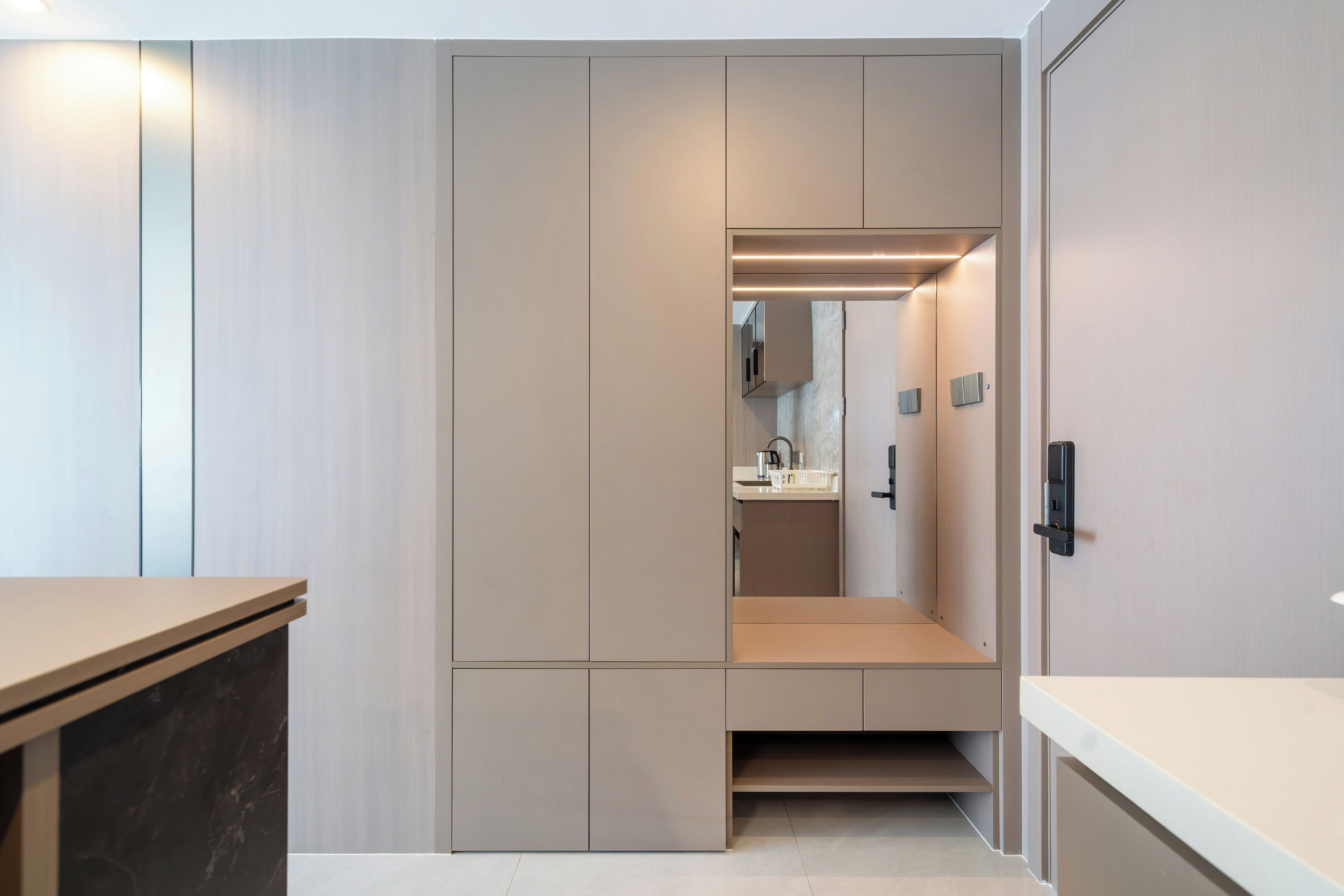 A modern, minimalist bathroom with a walk-in shower, a mirror, and a toilet.